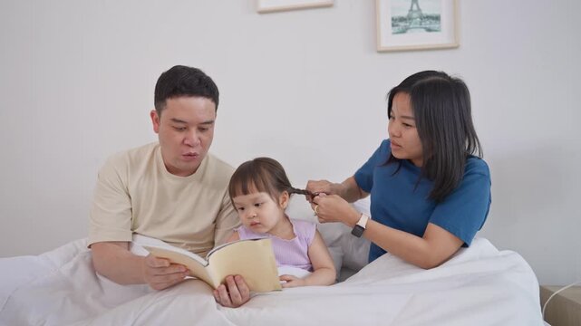 Asian mature parents lovingly care for and raises baby girl at home. 