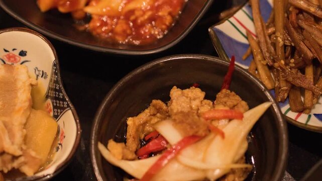 Assorted Japanese Izakaya Side Dishes and Appetizers in Ceramic Bowls