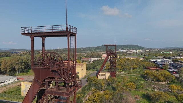 Headframes (Pithead Towers) Serbariu Mine (Grande Miniera di Serbariu) In Carbonia, Sardinia, Italy. Aerial Drone Shot