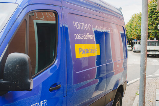 Poste Italiane delivery van on street delivering mail and parcels, transport and logistics services in Italy