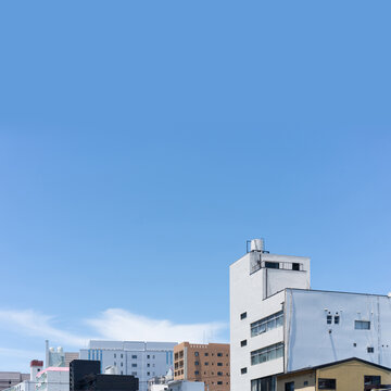 Cityscape of Fukuoka, Japan with mixed buildings and expansive blue sky copy space