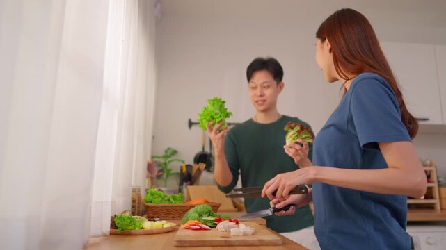 Asian young new marriage couple spend time together in kitchen at home. 
