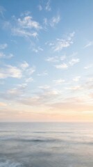 Fototapeta premium Serene Ocean Horizon with Soft Clouds at Sunrise.