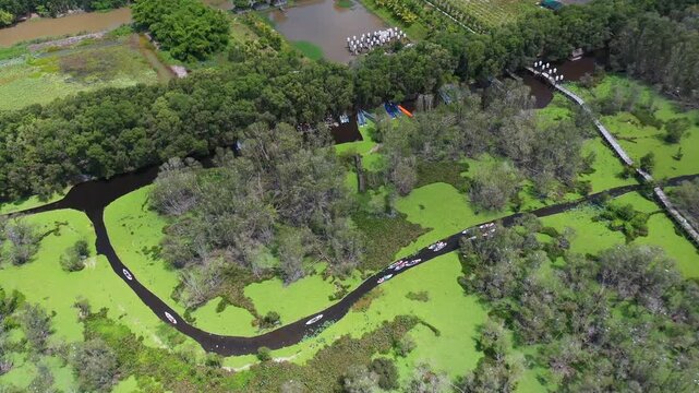 Aerial view of Tram Chim National Park wetlands with tourist boats and waterways in Vietnam
