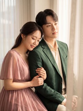 Couple sharing quiet romance in soft early morning light indoors