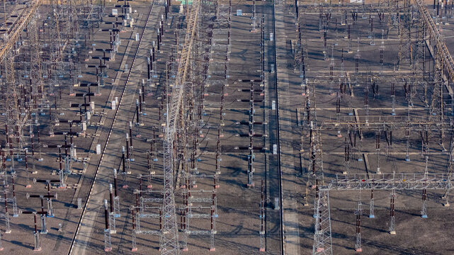 Aerial view of an electrical substation featuring complex power lines, transformers, and metal structures in Klaten, Central Java, Indonesia.