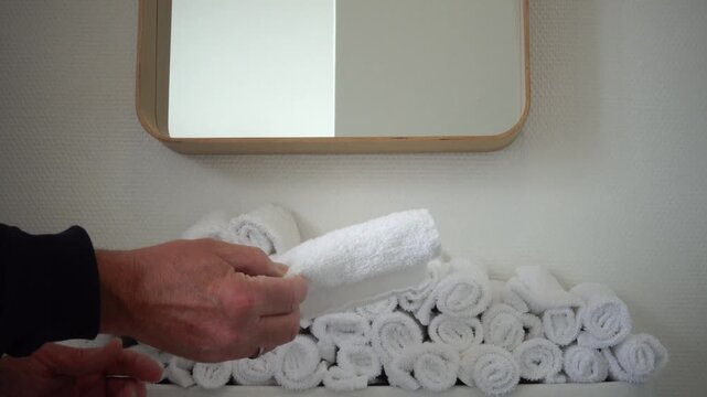 Roskilde, Denmark A man in a public bathroom uses cloth towels to dry his hands after washing. 