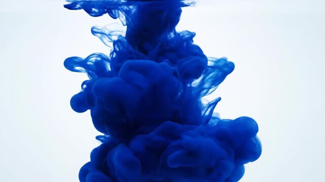 Vibrant Dark Blue Ink Swirling and Dissolving Inside Clear Water