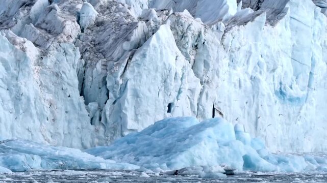 Majestic Blue Glacier Ice Wall with Jagged Peaks and Arctic Birds Over Cold Sea