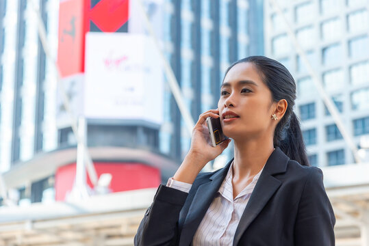 Young thoughtful Asian business woman working in modern office