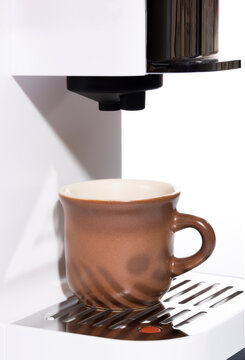 A coffee cup is in the automatic coffee machine