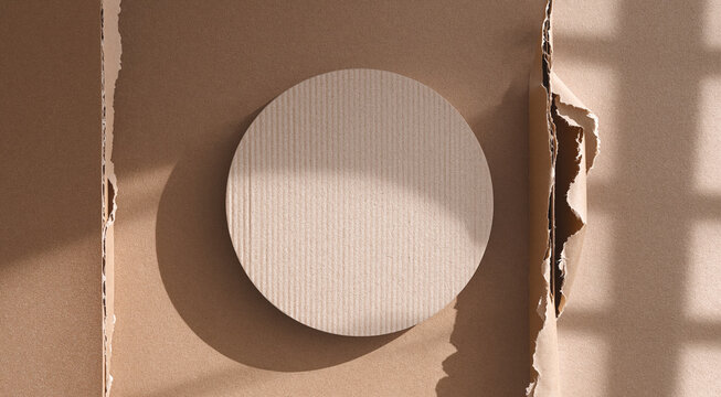 Circle paper mockup framed by torn brown cardboard with soft window shadows on a beige background
