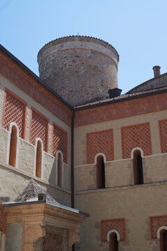 View of the historic courtyard and cylindrical tower at Rocchetta Mattei Castle in Grizzana Morandi, Emilia-Romagna, Italy.