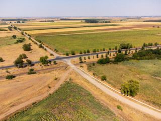 A striking drone photo series capturing the stark reality of climate change on the Great Hungarian Plain (Alföld), showcasing vast, cracked earth, sun-bleached yellow fields, and parched landscapes un © Fulop