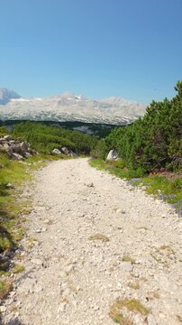 First-person view hiking on an Alpine mountain trail, exploring new areas and embracing adventure.