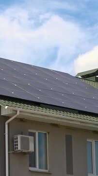 Solar panels installed on the roof of a city building. Concept of eco friendly and alternative power source - Vertical Video