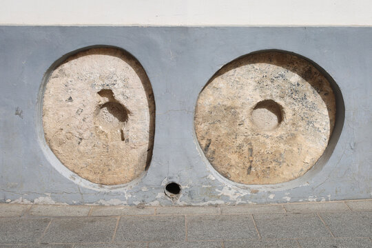 Old millstones embedded to prevent carriages from breaking the walls in The Jewish Quarter of Seville city