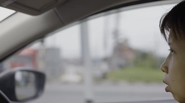Asian Woman While Driving A Car