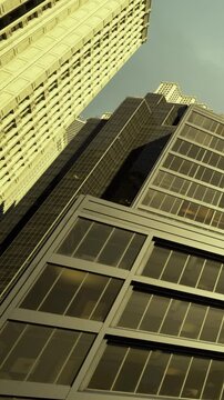 Steel and glass structures stretch toward the heavens in this bustling city scene. Sunlight casts intricate shadows, highlighting the unique architecture of modern buildings.