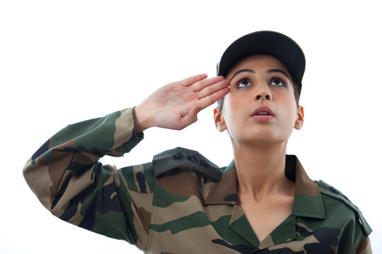 Close-up of female soldier saluting looking up 
