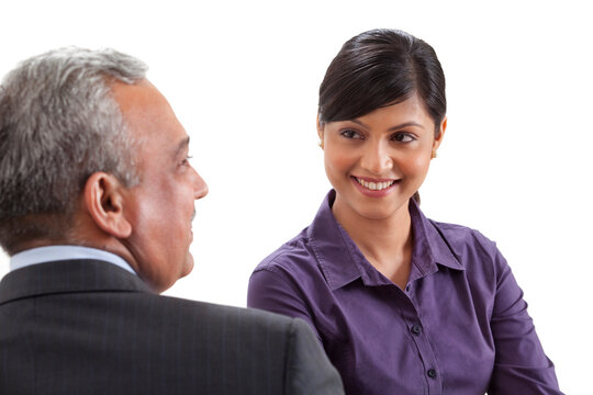 Business executives conversing on white background 