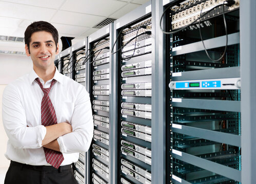 Smiling businessman in server room 