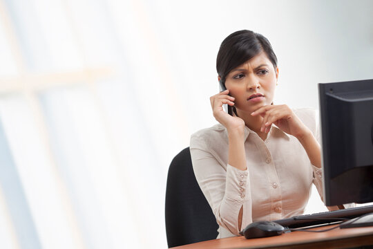 Contemplative businesswoman on call 