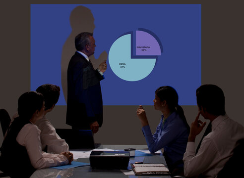Businessman giving presentation on projection screen 