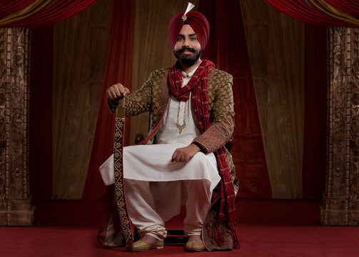 Portrait of well dressed man sitting on chair 