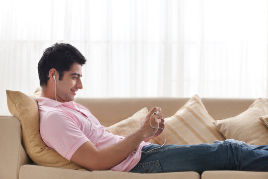 Handsome young man relaxing while listening to music 