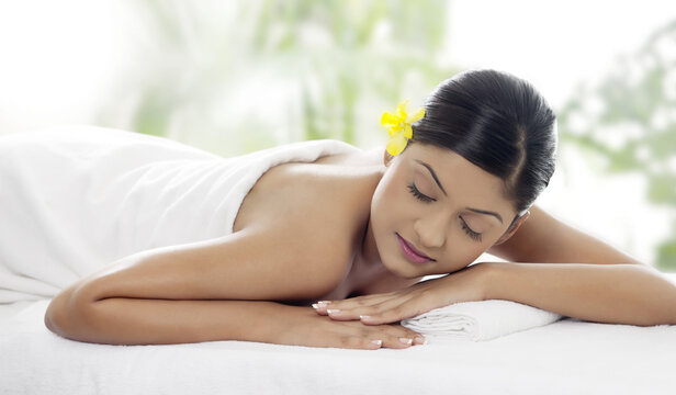 Pretty young woman lying on massage table 