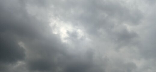 Fototapeta premium Dark storm clouds with a break in the sky revealing light 