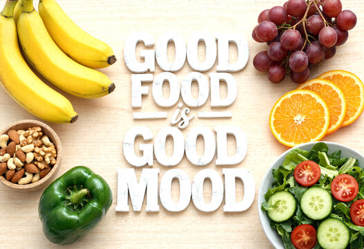 Fresh and healthy assortment of fruits vegetables nuts and salad showing good food is good mood concept