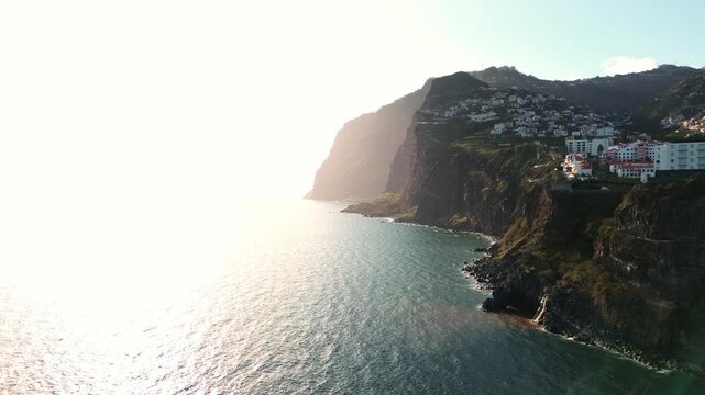 sunset aerial view of C&acirc;mara de Lobos fishing village on Madeira Island, Portugal