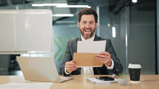 Professional opens important mail at workplace. Finds exciting information within envelope. Displays joy, success upon reading contents. Celebrates achievement with triumphant gesture.