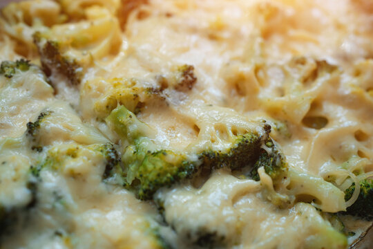 fresh delicious baked broccoli with melted cheese and spaghetti pasta