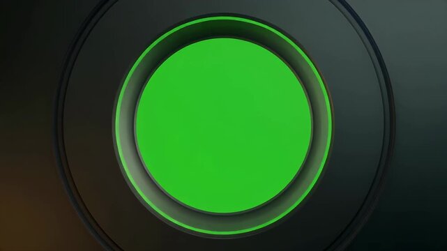 A close-up view of a circular green screen area framed by dark metallic concentric rings.