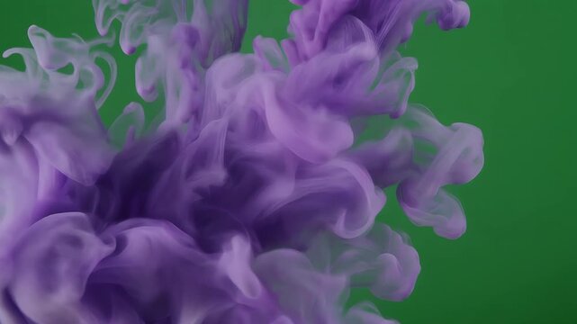 A vibrant purple cloud of ink swirls in water against a stark green background, creating an abstract and dynamic visual effect.