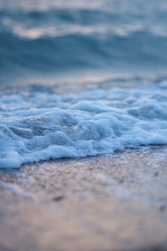 Vertical landscape image of sea wave splashing on beach