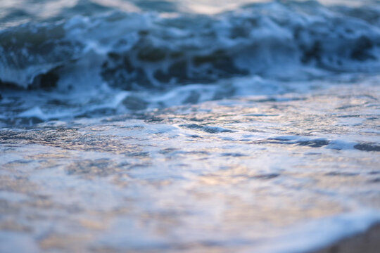 Landscape image of sea wave splashing on beach