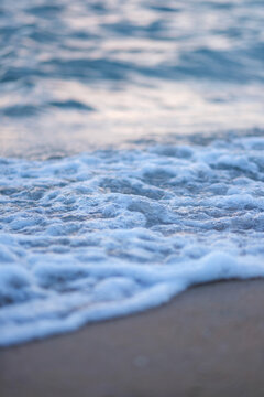 Vertical landscape image of sea wave splashing on beach