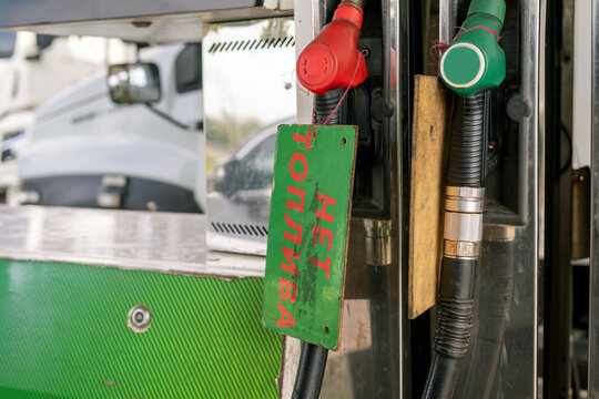 Fuel nozzles on a stand at  ​​gas station. Fuel shortage. Global crisis. No fuel plate