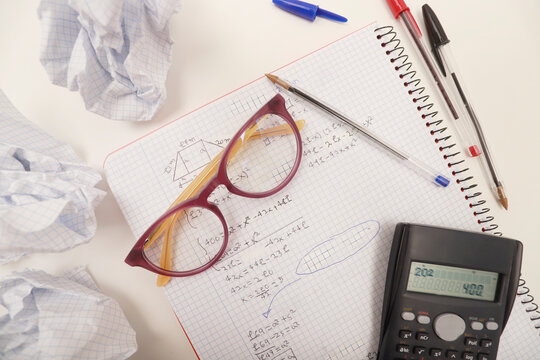 Mathematics study frustration with crumpled paper and calculator