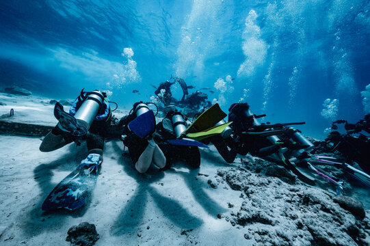 Group of scuba divers resting on the ocean floor