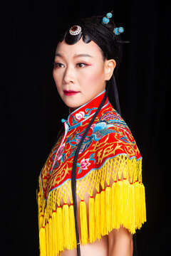 Traditional Chinese opera embroidery women in formal attire against a black background
