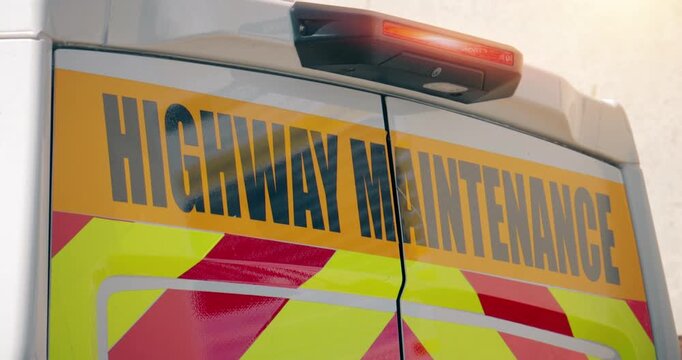 Highway road maintenance &ndash; traffic sign on motorway repair van with flashing light.