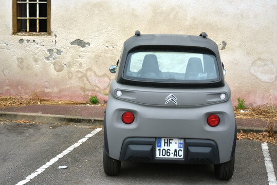 St-Amand Montrond - France - 17 August 2026 - Grey Citro&euml;n Ami electric microcar photographed from the rear while parked in a parking lot. 
