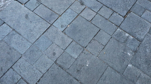 High angle close up of grey stone paver sidewalk texture