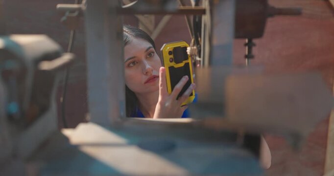 Female Entrepreneur Takes Machinery Photos for Custom DIY Project in Workshop