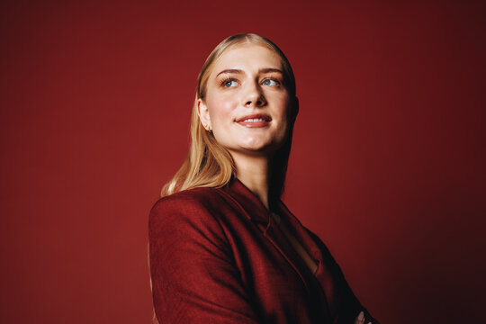 Leadership defines the business woman in a red suit during this studio portrait